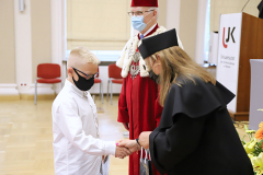 JM Rektor UJK prof. dr hab. Stanisław Głuszek, dr hab. Anna Wileczek, prof. UJK i chłopiec odbierający dyplom